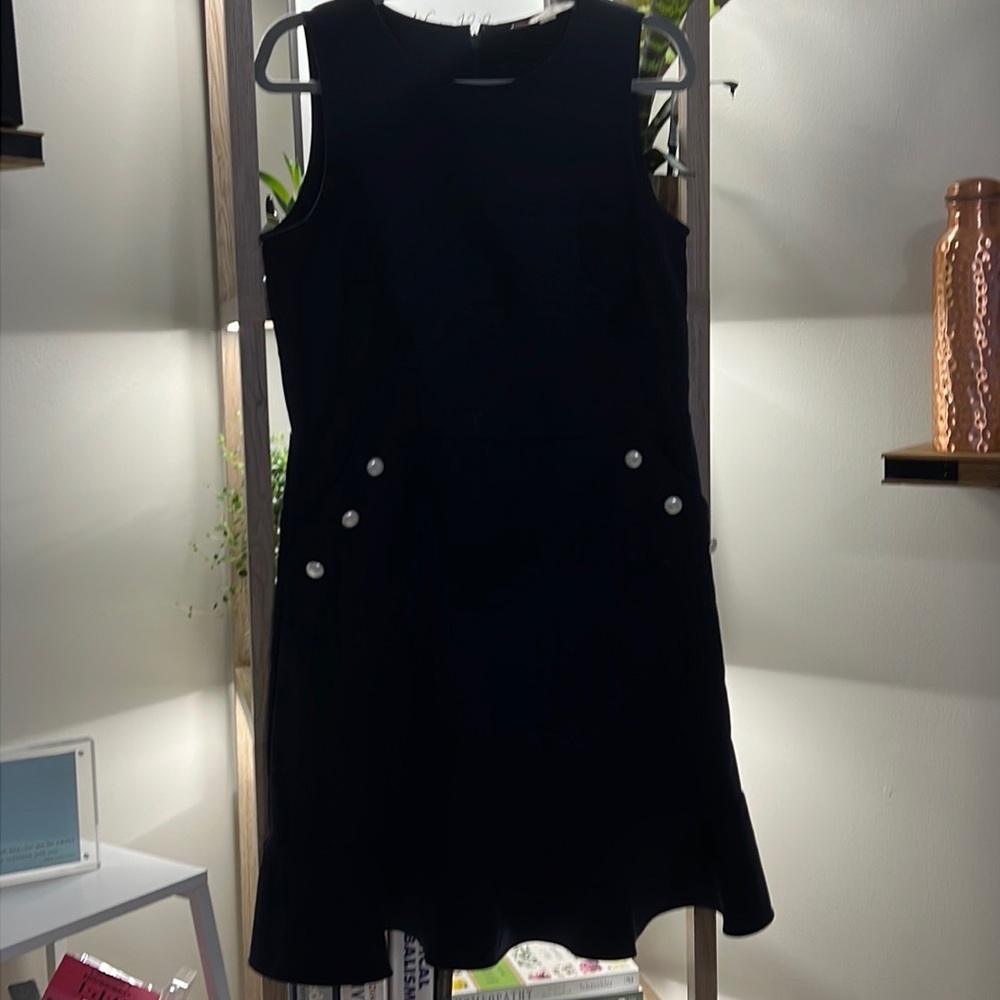 Flirty little black dress with pockets and pearls.